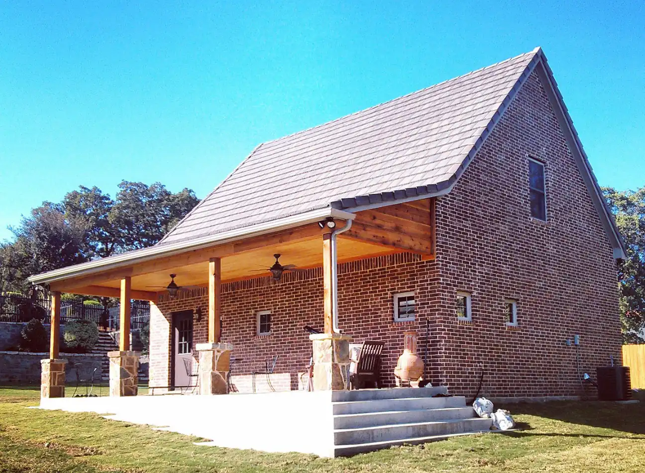 Brick custom garage with a covered porch in Southlake, TX